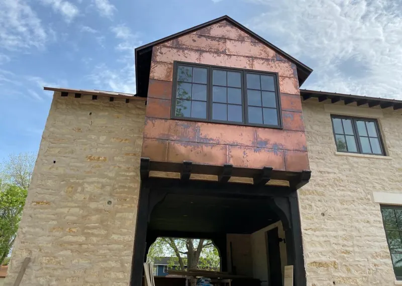 Copper metal panel facade on a stone building for Skylight Installation in Winter Springs