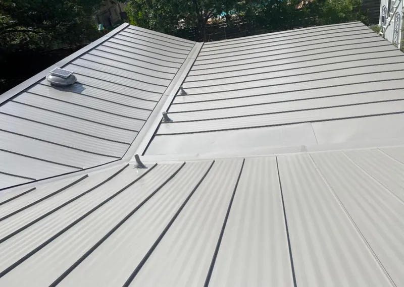 Solar attic fan installed on a metal roof for Roof Ventilation in Winter Springs